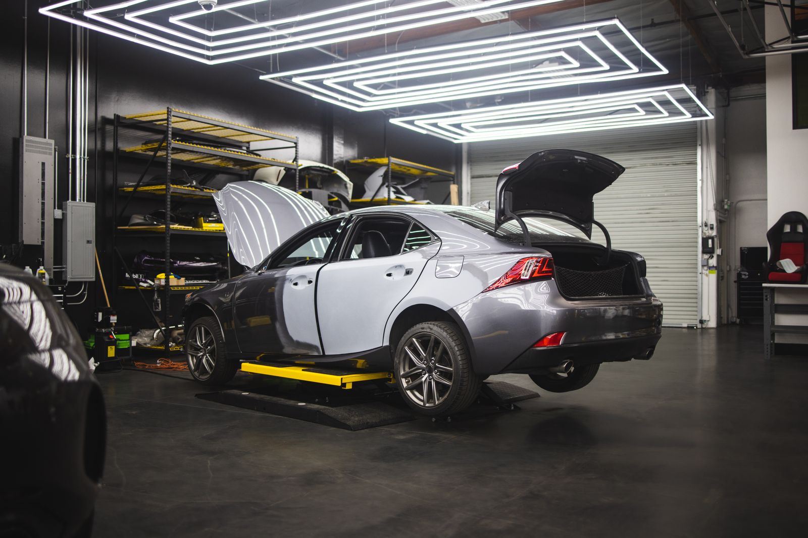 A car being serviced inside a clean, modern auto repair shop