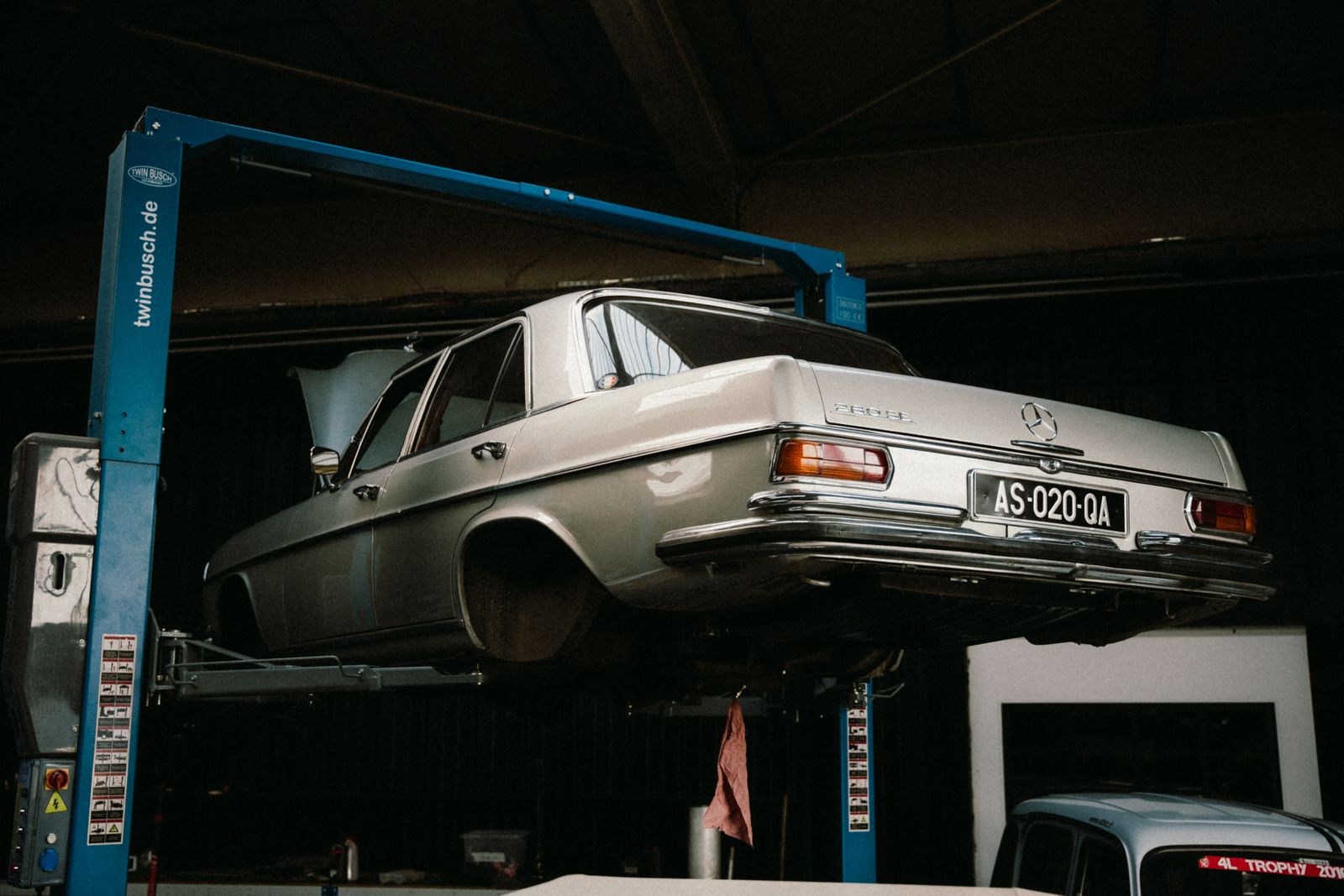 A vehicle raised on a two-post lift in the repair bay